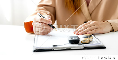 Customer hand signed the insurance contract documentation agreement for commercial auto car loan buying or vehicle rental service Customer hand signed the insurance contract documentation agreement for commercial auto car loan buying or vehicle rental service 118731315