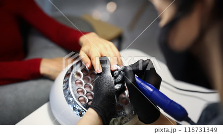 Nail master use special equipment for working with clients manicure 118731349