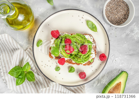 Avocado Toast for breakfast or lunch with avocado, raspberries, cream cheese and chia seeds. Vegetarian food. Clean eating. Top view. Copy space 118731366
