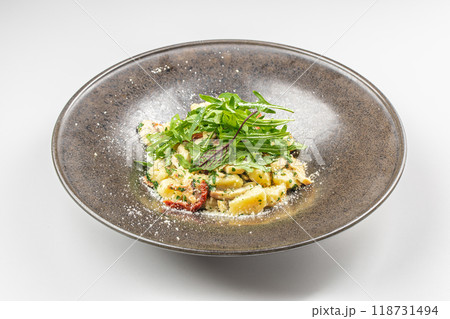 Italian Traditional potato gnocchi with smoked bacon, arugula, parmesan cheese. Top view. Copy space Italian Traditional potato gnocchi with smoked bacon, arugula, parmesan cheese. Top view. Copy space 118731494
