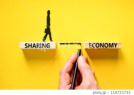 Sharing economy symbol. Concept words Sharing economy on beautiful wooden blocks. Businesswoman icon. Beautiful yellow table yellow background. Business sharing economy concept. Copy space. Sharing economy symbol. Concept words Sharing economy on beautiful wooden blocks. Businesswoman icon. Beautiful yellow table yellow background. Business sharing economy concept. Copy space. 118731731