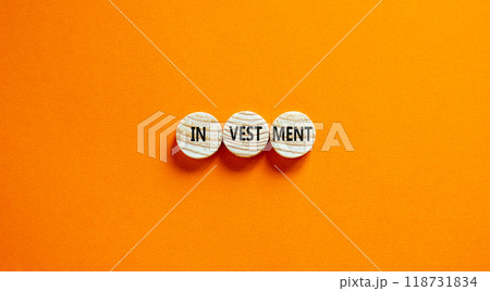 Investment symbol. Concept word Investment on beautiful wooden circles. Beautiful orange background. Business investment concept. Copy space. 118731834
