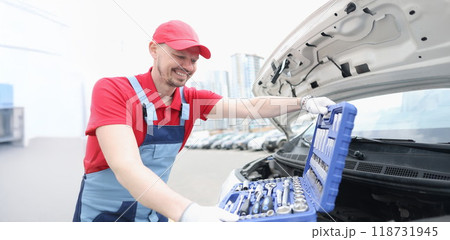 Automotive technician smiling and open kit full of equipments Automotive technician smiling and open kit full of equipments 118731945