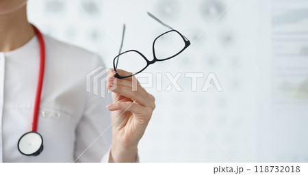 Professional doctor ophthalmologist hold glasses in black frame 118732018