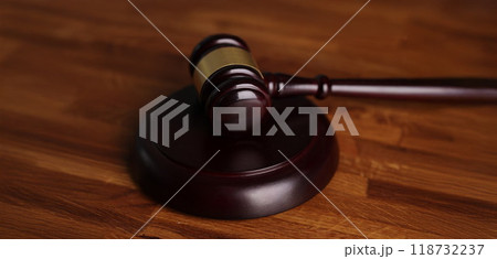 Judges wooden hammer on soundboard placed on wooden table Judges wooden hammer on soundboard placed on wooden table 118732237
