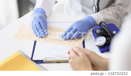 Professional cardiologist doctor examine electrogram scheme in clinic 118732252