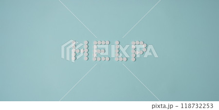 Help lettering made with white round shaped pill, drug prescription for treatment 118732253