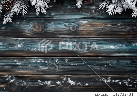 A wooden background of gray color is framed by spruce branches and crushed by snow. 118732431