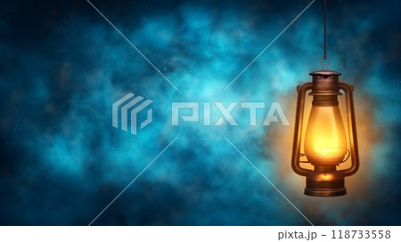 A beautiful, antique, kerosene lantern on a dark blue foggy background. Copy space. 118733558