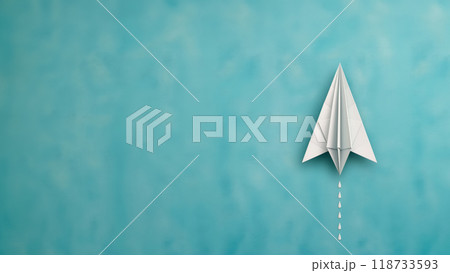 Paper airplane on a turquoise background. Copy space. 118733593