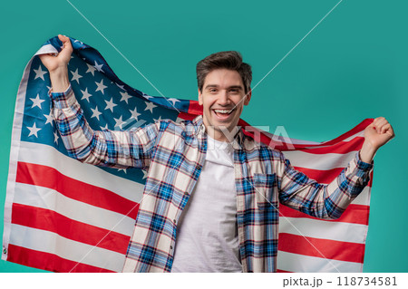 Happy mature man with national USA flag on blue background. American patriot 118734581