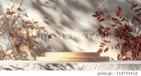 A serene display setup with wooden platforms and autumn leaves in soft natural light during the golden hour. A serene display setup with wooden platforms and autumn leaves in soft natural light during the golden hour. 118735418