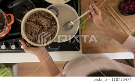 Top view of woman making chocolate sauce for sweet desert Top view of woman making chocolate sauce for sweet desert 118736474