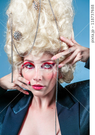 Glamourous female model wearing huge blond wig 118737688