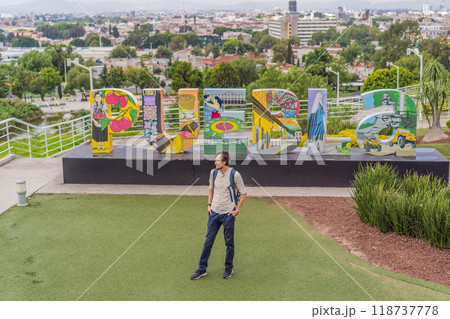 Male tourist in front of the panoramic view of Puebla city, Mexico. Travel, cultural exploration, and scenic landscape concept 118737778