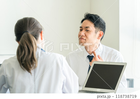 喉の不調を医師に相談するビジネスマン(インフルエンザ・扁桃炎・風邪・咽頭炎) 喉の不調を医師に相談するビジネスマン(インフルエンザ・扁桃炎・風邪・咽頭炎) 118738719