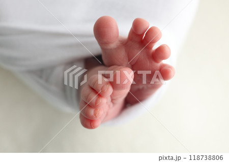 Foot of a newborn. Close up feet, toes, heels, feet of a newborn baby. Studio monochrome, vintage style, black and white macro photography. Foot of a newborn. Close up feet, toes, heels, feet of a newborn baby. Studio monochrome, vintage style, black and white macro photography. 118738806