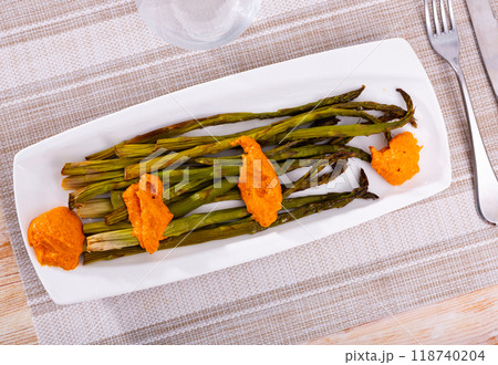 Plate of roasted green asparagus with Romesco sauce 118740204