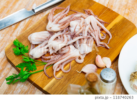 Raw squid tentacles on wooden board prepared for cooking 118740263