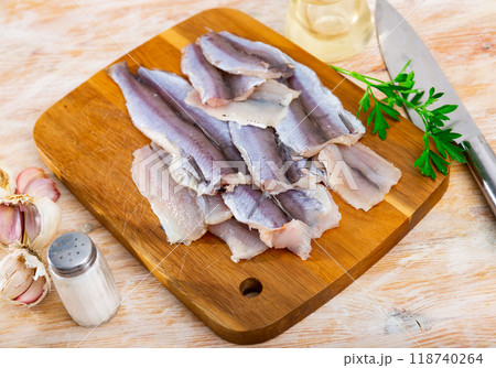 Raw whiting fish fillet on wooden board prepared for cooking 118740264