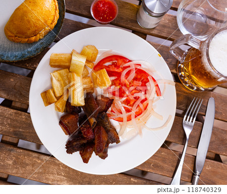 Braised chicharron with fried yuca and salad 118740329