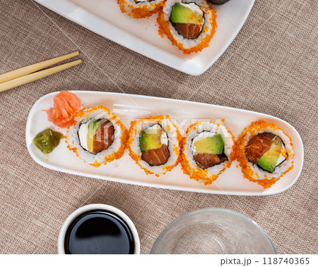 Japanese dish california roll masago with salmon, avocado, cheese and caviar closeup 118740365