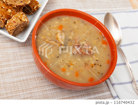 Pearl barley soup with pork and mushrooms 118740432