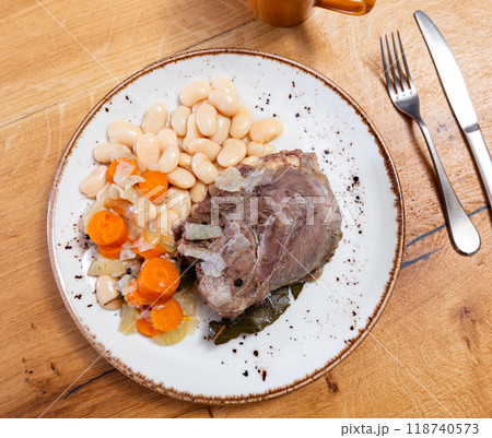 Stewed pork cheek with white beans on ceramic plate 118740573