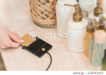 美容室・ヘアサロンでクレジットカード決済・オンライン決済・キャッシュレス決済をする女性（電子決済） 118741415