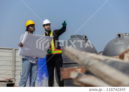 Construction civil engineer man and woman African American checking quality 118742845