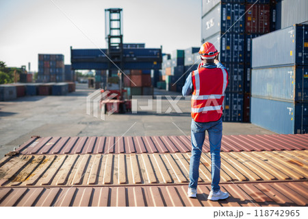 Man american african with talkie walkie at worker industry dock or container yard. 118742965