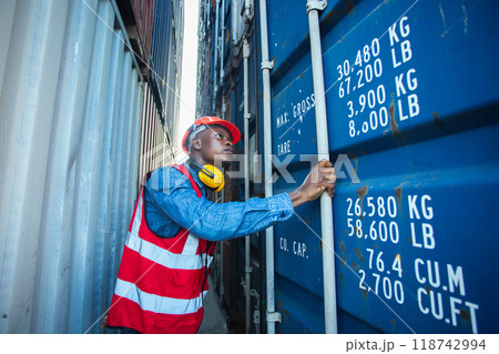 Male african american foreman opening door of container. Male african american foreman opening door of container. 118742994