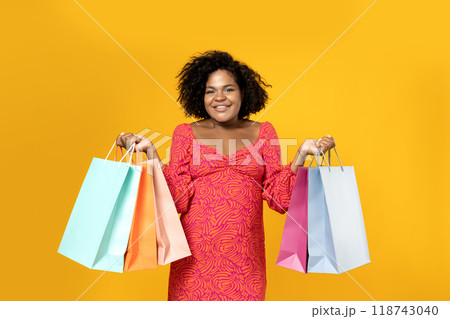 Young girl with shopping bags in her hands Young girl with shopping bags in her hands 118743040