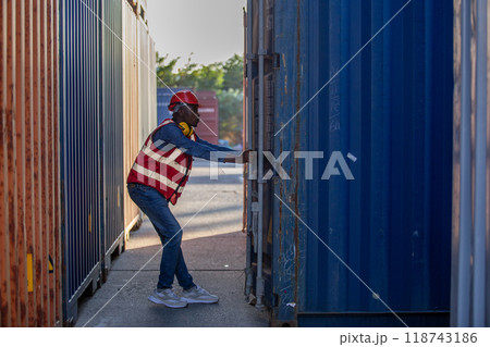 Male african american foreman opening door of container 118743186