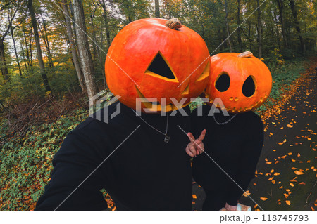 couple taking selfie with pumpkin head couple taking selfie with pumpkin head 118745793