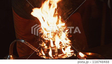 Varanasi, Uttar Pradesh, India. Candle Holder With Lit Candles On Ganga Maha Aarti Ceremony Begins. Fire Puja Ritual In Varanasi. Traditional Ganga Aarti At Ghat 118748488