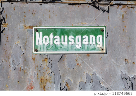 Green plate with a white inscription - emergency exit 118749665