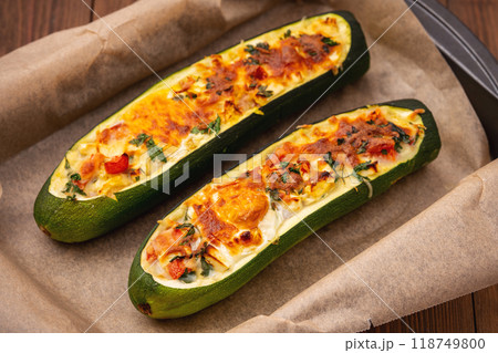 Zucchini stuffed with feta cheese, egg, parsley and cherry tomatoes Zucchini stuffed with feta cheese, egg, parsley and cherry tomatoes 118749800
