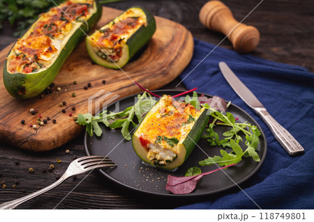 Zucchini stuffed with feta cheese, egg, parsley and cherry tomatoes 118749801
