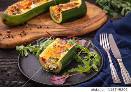 Zucchini stuffed with feta cheese, egg, parsley and cherry tomatoes Zucchini stuffed with feta cheese, egg, parsley and cherry tomatoes 118749802