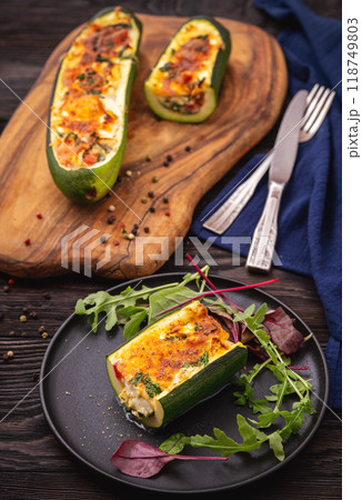 Zucchini stuffed with feta cheese, egg, parsley and cherry tomatoes 118749803