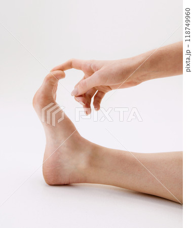 Cropped close-up image of female feet isolated on white studio background Cropped close-up image of female feet isolated on white studio background 118749960