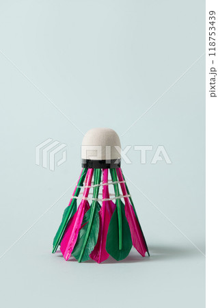 Colorful badminton feather shuttlecock on blue background. Close up. Vertical. Concept racket sport. Leisure games. 118753439