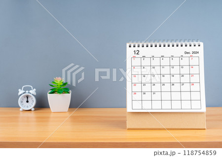 December 2024, Monthly desk calendar for 2024 year on wooden table with grey background. 118754859