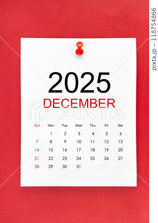 December 2025 calendar page with push pin on red background. 118754866