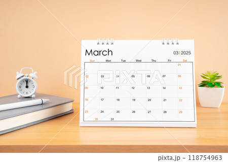 March 2025, Monthly desk calendar for 2025 year on wooden table. 118754963