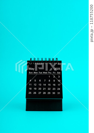 Black Calendar for May 2025. Desktop calendar on a green background. 118755200