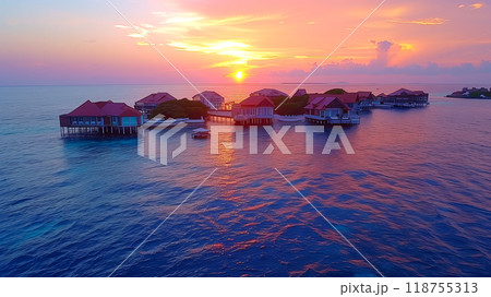 Colorful Sunset Over Water Villas on the Maldives Coastline During a Tranquil Evening 118755313