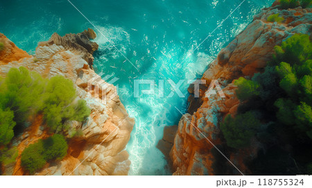 Aerial View of Vibrant Turquoise Waves Crashing Against Rocky Cliffs in Sunny Coastal Landscape Aerial View of Vibrant Turquoise Waves Crashing Against Rocky Cliffs in Sunny Coastal Landscape 118755324