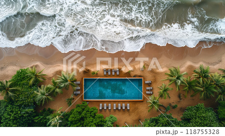 Aerial View of a Serene Beach With a Pool Nestled Among Palm Trees at Sunset 118755328